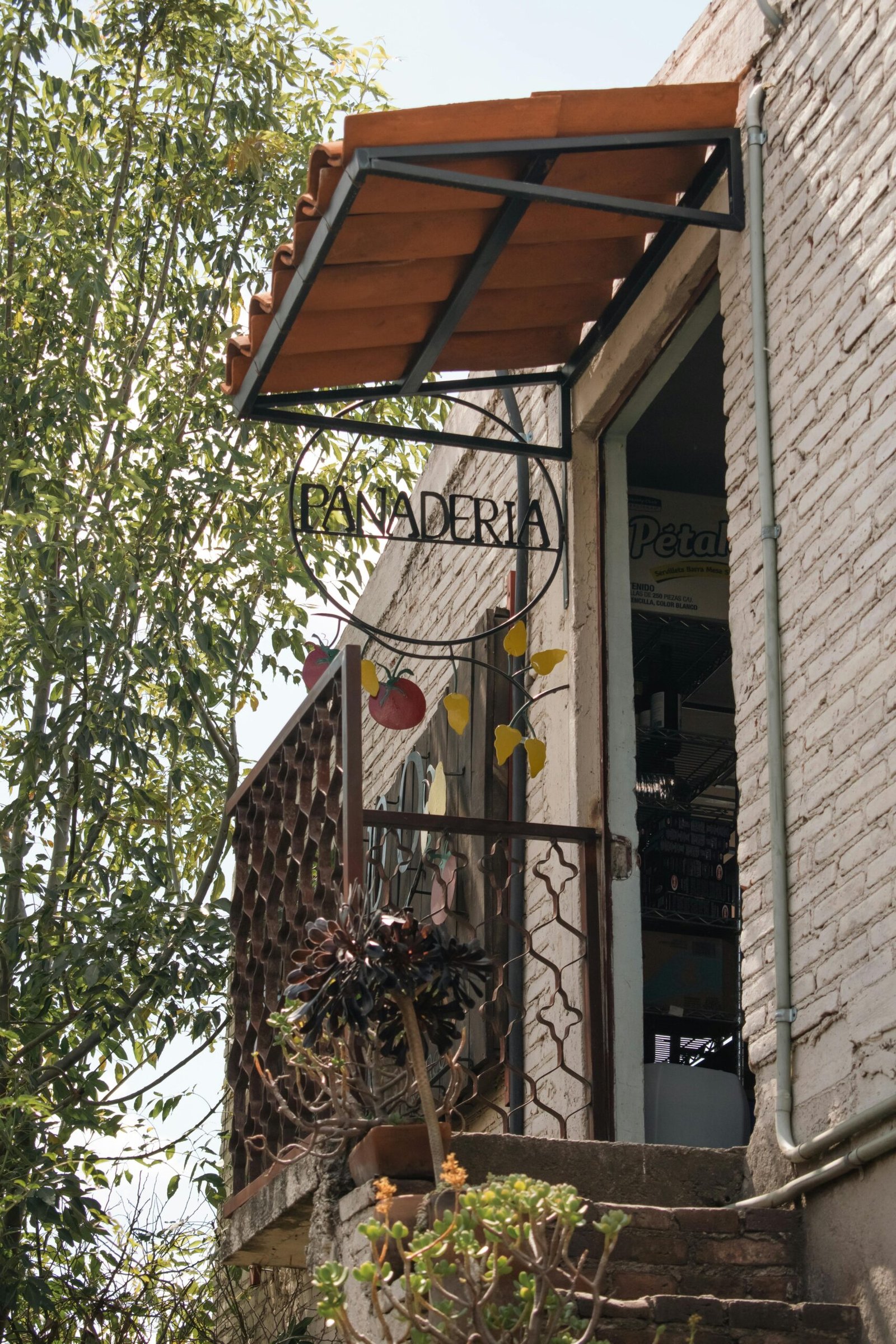 Rustic panaderia entrance with a canopy and metal railings in Cholula, Pue., México.